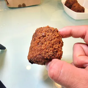 a hand holding a piece of food