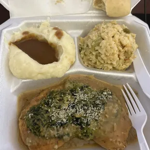 Spinach Chicken, rice dressing, mashed potatoes and gravy, and a roll of