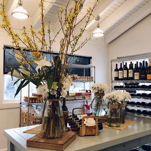 vases of flowers and bottles of wine