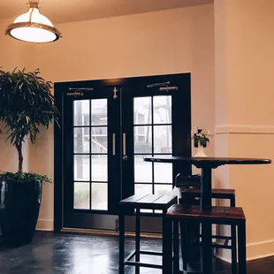a table and chairs in front of a door