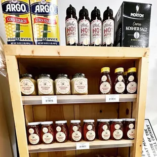 a shelf full of jars of food