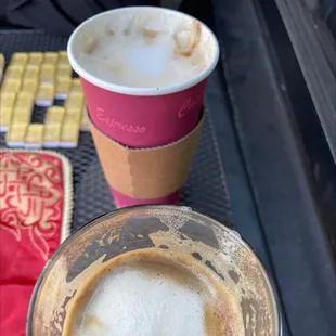a cup of espresso next to a cup of coffee