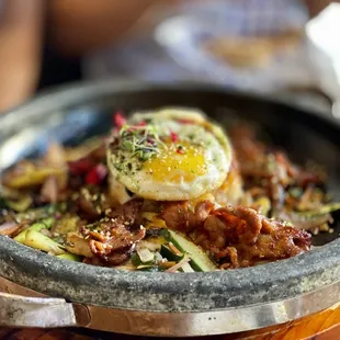 Crispy rice, veggies and meat on a hot stone bowl. Yum!