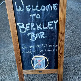 a blackboard with a sign that says welcome to berkley bar