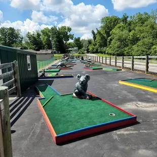 Mini-golf area, while looking good it becoming un-playable because of ground settling - Cups are above putting surface. balls won't drop.
