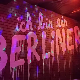 a brick wall with graffiti on it