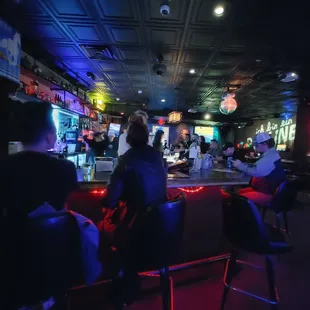 a group of people sitting at a bar
