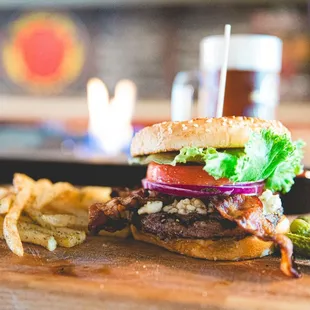 a burger and fries on a cutting board