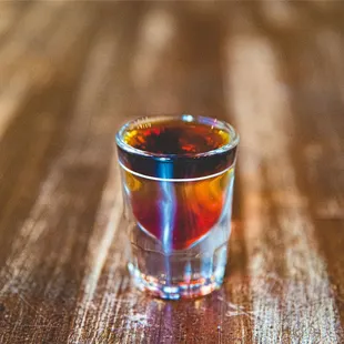 a shot of alcohol on a wooden table