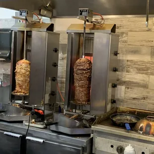 two kebabs being cooked in a commercial kitchen