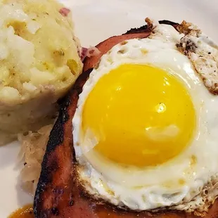 Leberkase: a loaf of ground pork, bacon &amp; corned beef that is browned &amp; served over Sauerkraut with a sunny side egg &amp; potato salad