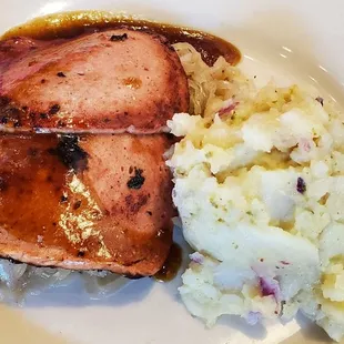 Leberkase: a loaf of ground pork, bacon &amp; corned beef that is browned &amp; served over Sauerkraut with Potato salad or French fries