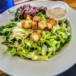 Caesar Salad  with Steak - chop romaine lettuce, croutons, parmesan cheese, Caesar dressing and steak.