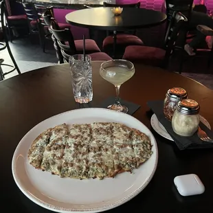 a plate of pizza and a glass of wine