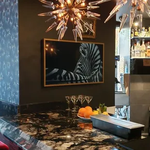 a bar with red chairs and a black counter