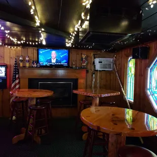 a bar with wooden tables and stools
