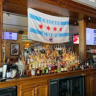 a chicago cubs flag hanging over the bar