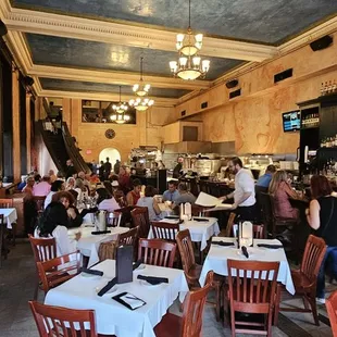 the interior of a restaurant with tables and chairs