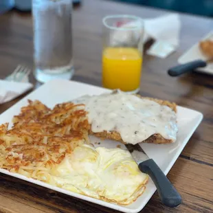 Country Fried Steak, Sunny Side Up eggs, and Hash Browns. Orange Juice (freshly squeezed)