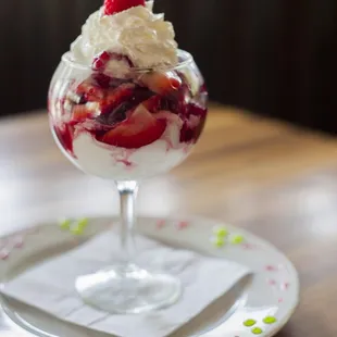 a dessert with whipped cream and strawberries