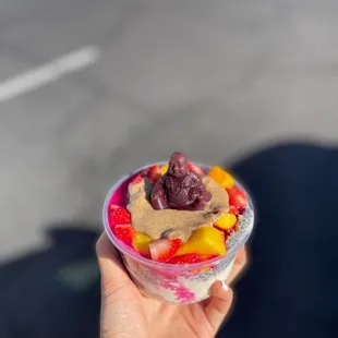 a person holding a bowl of fruit