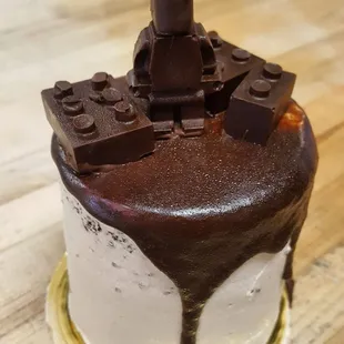 a chocolate frosted cake with legos on top