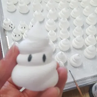 a person holding a small white object