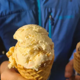 two people holding ice cream cones