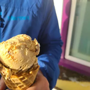 a man holding a cone of ice cream