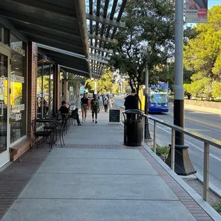 people walking down the sidewalk