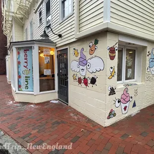 the front of a building painted with cartoon characters