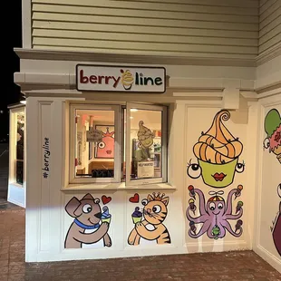 a storefront with cartoon characters painted on it