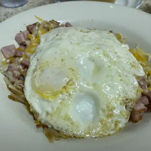 Ham and cheese over hash browns with 2 eggs over medium