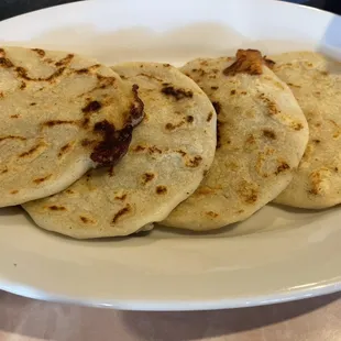 Papusas, the best one is the pork. Hand made!!!!  There&apos;s meat inside.