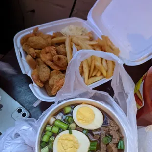 a bowl of soup, french fries, and a sandwich