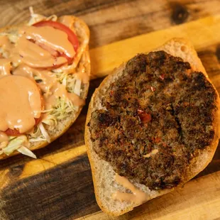 a burger on a wooden cutting board