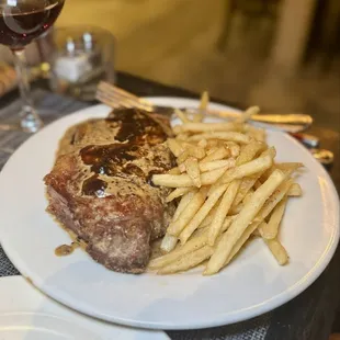 Steak Frites - seared New York strip steak with a classic cream, cognac and peppercorn sauce
