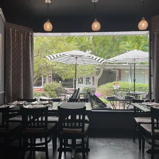 a view of a dining room with tables and umbrellas