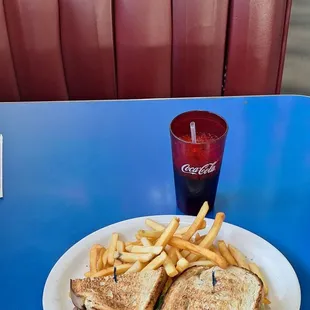 Bert's Club sandwich with fries and a Coca Cola products refilled soft drink made for lunch and dinner.