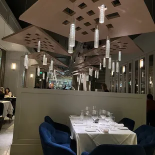 a dining room with blue chairs and a white table