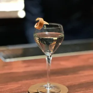 a glass of water with a garnish on top