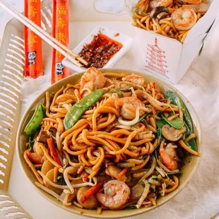 a bowl of noodles and chopsticks