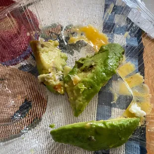 Egg White, Cheddar and molded Avocado Croissant Breakfast Sandwich.