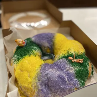 a mardi gras donut in a box