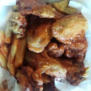 Chicken wings with mild sauce. Nice sized, crispy with delicious flavor. Comes with fries and bread.