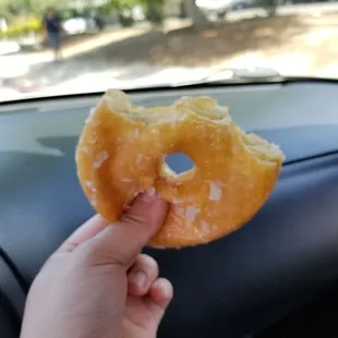 a hand holding a donut