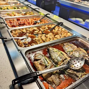 a variety of food in a buffet