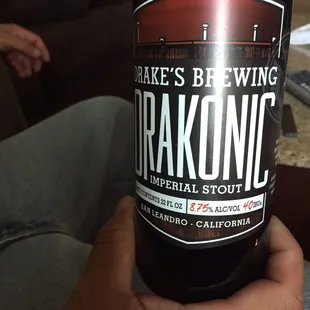 a person holding a bottle of beer