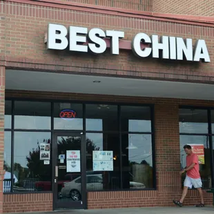 a man walking past a best china store
