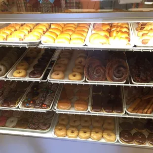 a variety of donuts in a display case